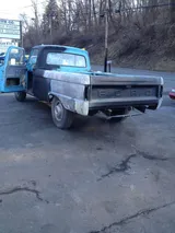 Classic Ford pickup stripped to bare metal outside the shop