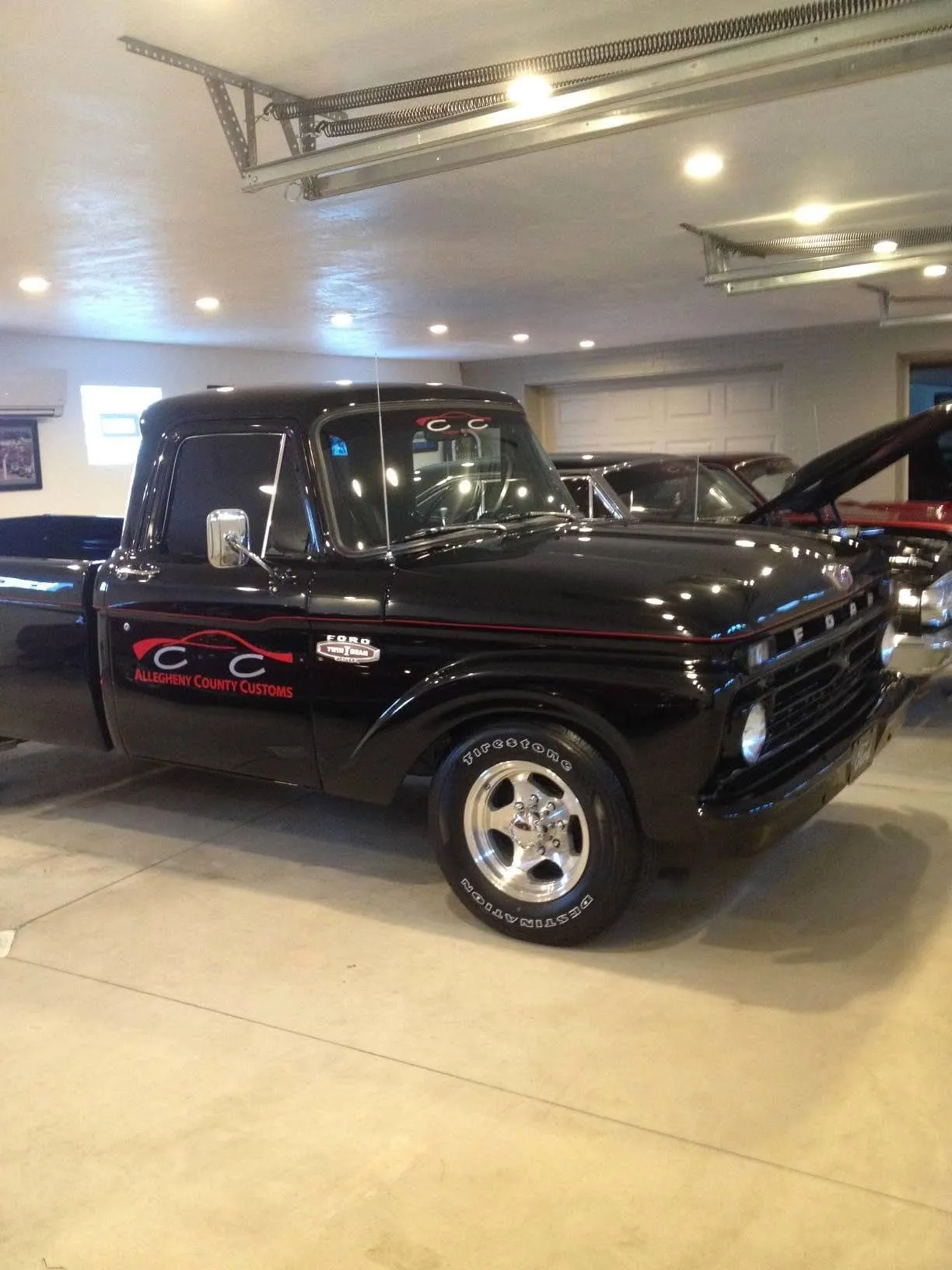 Finished classic Ford pickup in gloss black with Allegheny County Customs lettering