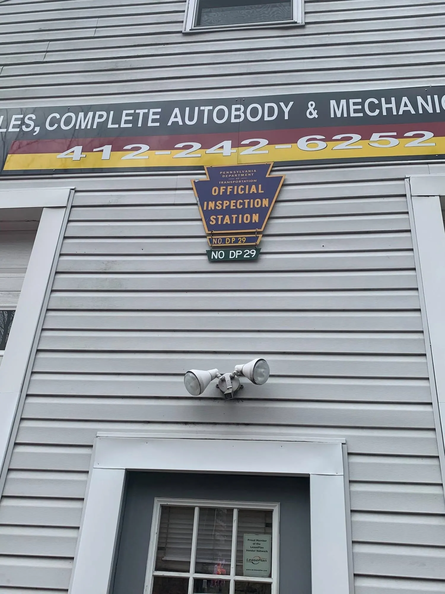 Official Inspection Station sign on the side of the ACC building