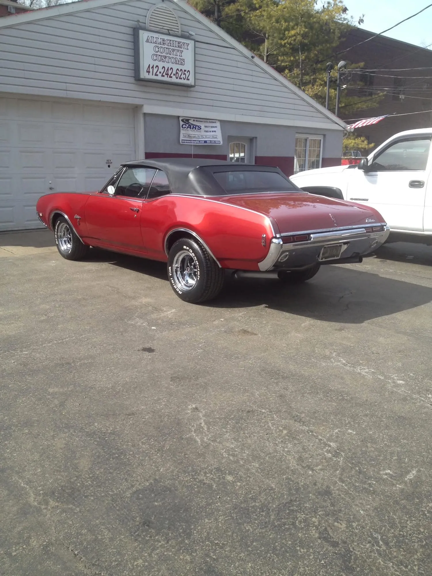Rear three-quarter view of the finished red Oldsmobile convertible